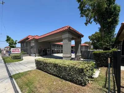 a building with a sign in front of it at Vista Motel - Riverside in Riverside
