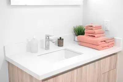 a bathroom sink with towels on a counter at Pacific Pearl 2 bed Apt with FREE PARKING in Santa Monica in Los Angeles