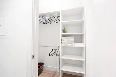 a walk in closet with white shelves at Pacific Pearl 2 bed Apt with FREE PARKING in Santa Monica in Los Angeles
