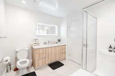 a bathroom with a toilet and a sink and a shower at Pacific Pearl 2 bed Apt with FREE PARKING in Santa Monica in Los Angeles