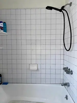 a shower in a bathroom with a white tile wall at Riverton Place NoHo in Los Angeles