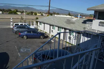 two cars parked in a parking lot next to a building at Villa Las Palmas Motel in Barton Heliport