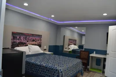 a hotel room with a bed and a mirror at Villa Las Palmas Motel in Barton Heliport