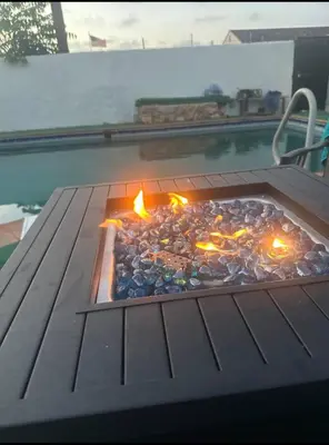a pizza sitting on top of a grill next to a pool at Luxury Master Bedroom with private bathroom walking distance to Sofi Stadium, KIA Forum and Intuit Dome also only train stop away from LAX airport Perfect place for tourists and event attendees in Inglewood