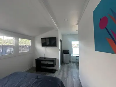 a bedroom with a bed and a flat screen tv at Luxury Master Bedroom with private bathroom walking distance to Sofi Stadium, KIA Forum and Intuit Dome also only train stop away from LAX airport Perfect place for tourists and event attendees in Inglewood