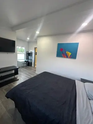 a bedroom with a bed and a flat screen tv at Luxury Master Bedroom with private bathroom walking distance to Sofi Stadium, KIA Forum and Intuit Dome also only train stop away from LAX airport Perfect place for tourists and event attendees in Inglewood