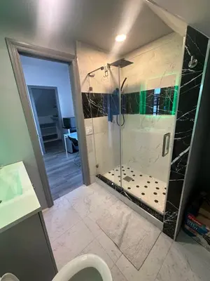 a bathroom with a shower with a toilet and a sink at Luxury Master Bedroom with private bathroom walking distance to Sofi Stadium, KIA Forum and Intuit Dome also only train stop away from LAX airport Perfect place for tourists and event attendees in Inglewood