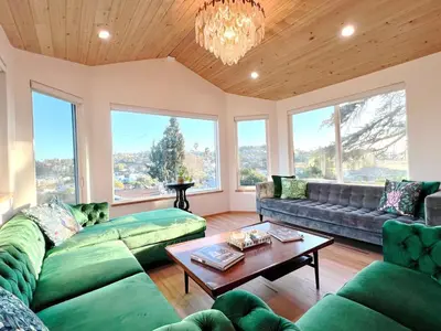 a living room with a couch and a table at The Perch- Hilltop Bungalow, Eagle Rock-near DTLA in Los Angeles