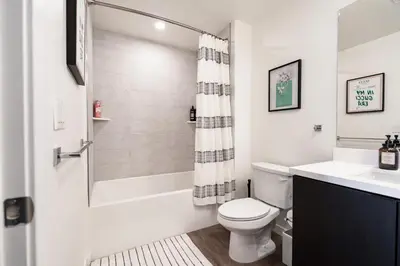 a white bathroom with a toilet and a shower at The Hollywood Highline 2 bed Apt WITH FREE PARKING in Hollywood in Los Angeles
