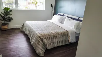 a bedroom with a bed with a blue headboard at Penthouse 2 Bedroom with Hollywood Sign View! in Los Angeles