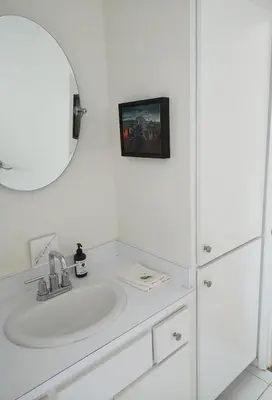 a white bathroom with a sink and a mirror at Venice Canals & Beach Guest Suite in Los Angeles