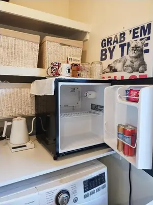 a cat sitting on a shelf next to a microwave at Venice Canals & Beach Guest Suite in Los Angeles