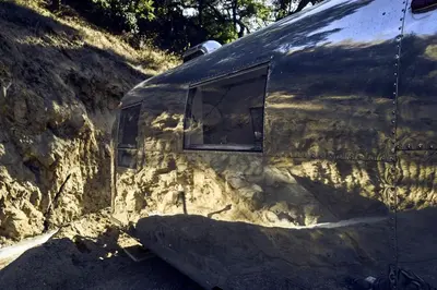 a side view of a trailer with two windows at Secluded Pet Friendly Airstream in Calabasas, California in Calabasas