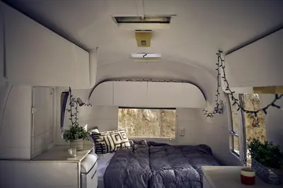 a bed in the middle of a room in a rv at Secluded Pet Friendly Airstream in Calabasas, California in Calabasas