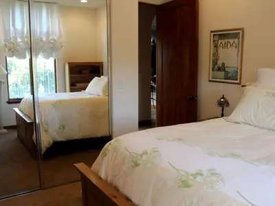 a bedroom with two beds and a mirror at Romantic and Relaxing Villa Retreat with a Jacuzzi near Somis, California in Somis