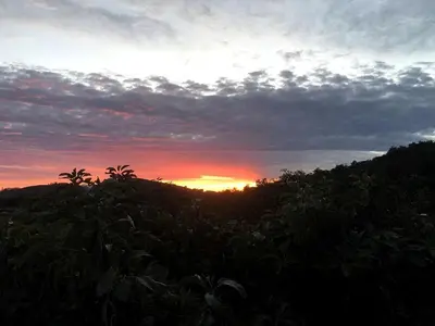 a sunset over a field with trees in the foreground at Romantic and Relaxing Villa Retreat with a Jacuzzi near Somis, California in Somis