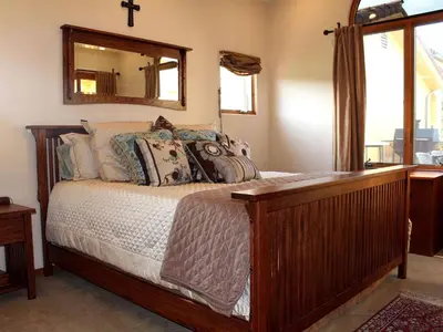 a bedroom with a bed with a mirror on the wall at Romantic and Relaxing Villa Retreat with a Jacuzzi near Somis, California in Somis