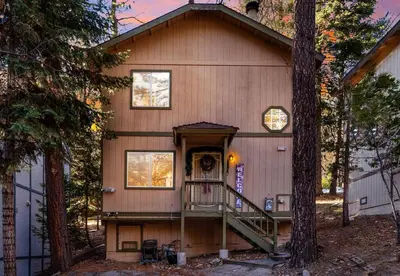 a house with a staircase leading to the front door at Charming Cabin for Winter and Water Sports Fans Near Big Bear Lake, California in Arrowbear Lake
