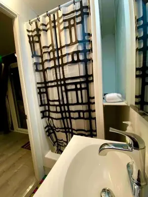 a bathroom with a sink and a shower at Fully Refurbished Container in Devore Heights, California, for Glamping Trips on Route 66 in Devore Heights