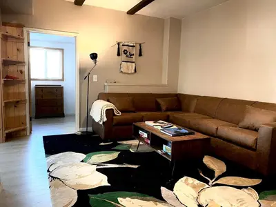 a living room with a couch and a table at Stunning Cabin with Indoor Jacuzzi Ideal for a Weekend Getaway from Los Angeles in Pine Mountain Club
