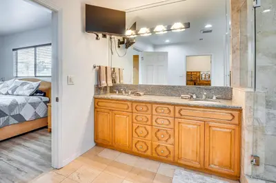 a bathroom with a sink and a shower and a bed at 8 Mi to Dtwn Home with Fireplace and Games in LA! in Los Angeles