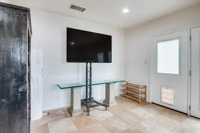 a room with a table with a tv on the wall at 8 Mi to Dtwn Home with Fireplace and Games in LA! in Los Angeles