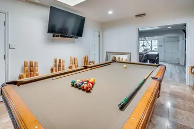 a pool table with balls on it in a living room at 8 Mi to Dtwn Home with Fireplace and Games in LA! in Los Angeles