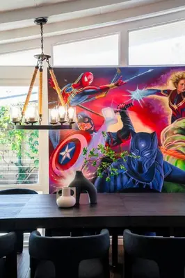a dining room with a superhero mural on the wall at Avengers HQ - Hot Tub - Close to Disney - Parking in Anaheim