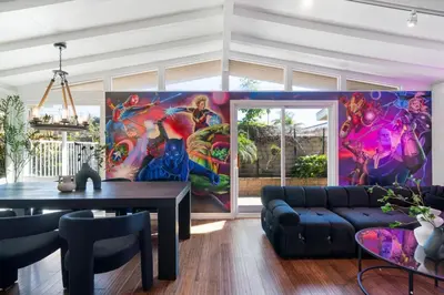 a living room with a large painting on the wall at Avengers HQ - Hot Tub - Close to Disney - Parking in Anaheim
