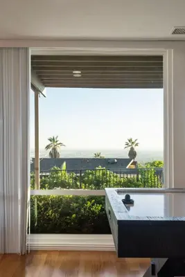 a room with a large window with a tub and a view at Overlooking Luxury - Pool Heat - Spa - Games in Pico Rivera