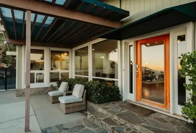 a home with a patio with a red door at Overlooking Luxury - Pool Heat - Spa - Games in Pico Rivera