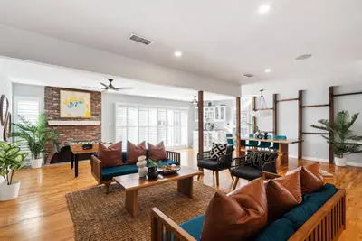 a living room with a couch and a table at Splash Haven-Heated Pool-Huge Living Area-Sleeps 8 in Long Beach