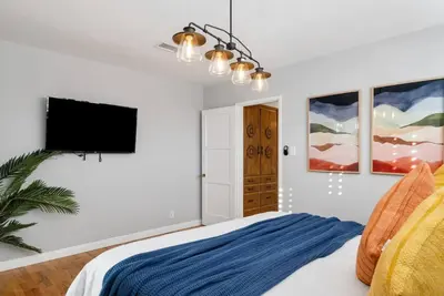 a bedroom with a bed and a flat screen tv at Splash Haven-Heated Pool-Huge Living Area-Sleeps 8 in Long Beach