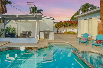 a swimming pool in front of a house at Splash Haven-Heated Pool-Huge Living Area-Sleeps 8 in Long Beach