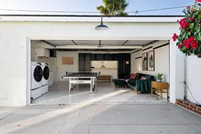 a garage with a ping pong table in it at Splash Haven-Heated Pool-Huge Living Area-Sleeps 8 in Long Beach
