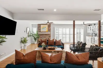 a living room with a couch and a table at Splash Haven-Heated Pool-Huge Living Area-Sleeps 8 in Long Beach
