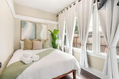 a bedroom with a bed with two towels on it at Sunset Shores - Near the beach - Games - Sleeps 8 in Long Beach