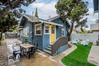 a blue tiny house with a table and chairs at Sunset Shores - Near the beach - Games - Sleeps 8 in Long Beach