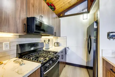 a kitchen with a stove and a microwave at 3 Mi to Lake Arrowhead Village Pine-View Home! in Lake Arrowhead
