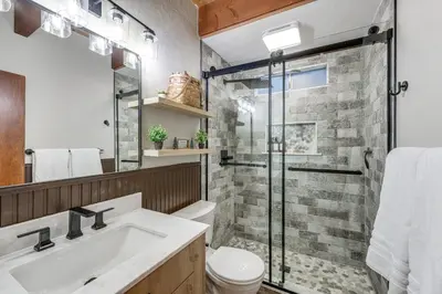 a bathroom with a shower and a toilet and a sink at 3 Mi to Lake Arrowhead Village Pine-View Home! in Lake Arrowhead