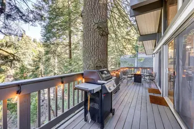 a screened in porch with a tree on the deck at 3 Mi to Lake Arrowhead Village Pine-View Home! in Lake Arrowhead