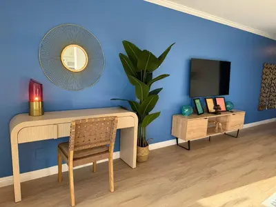 a room with a table and a mirror and a tv at Redondo Oceanfront Gem 2BR BA Balcony & Parking 335 in Redondo Beach