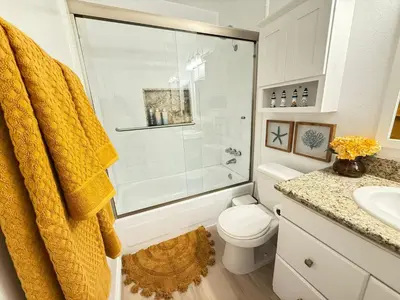 a bathroom with a shower and a toilet and a sink at Redondo Oceanfront Gem 2BR BA Balcony & Parking 335 in Redondo Beach