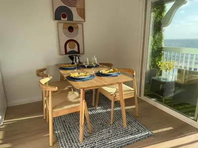 a dining room table and chairs with a view of the ocean at Redondo Oceanfront Gem 2BR BA Balcony & Parking 335 in Redondo Beach