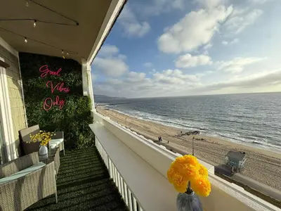 a view of the beach from the balcony of a beach house at Redondo Oceanfront Gem 2BR BA Balcony & Parking 335 in Redondo Beach
