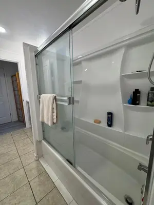a shower with a glass door in a bathroom at Walk of Fame 1 Bedroom with shared bathroom and kitchen in Los Angeles