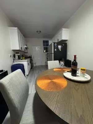a kitchen with a table with a bottle of wine on it at Walk of Fame 1 Bedroom with shared bathroom and kitchen in Los Angeles