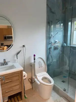 a bathroom with a shower and a toilet and a sink at Guest House in Los Angeles