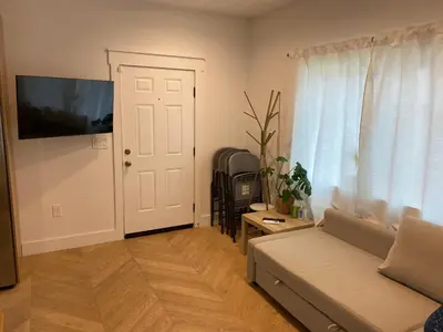 a living room with a couch and a window at Guest House in Los Angeles