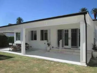 a white house with a porch and a patio at Guest House in Los Angeles